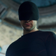 Matt Murdock in his Black Daredevil outfit standing in a church of some kind.